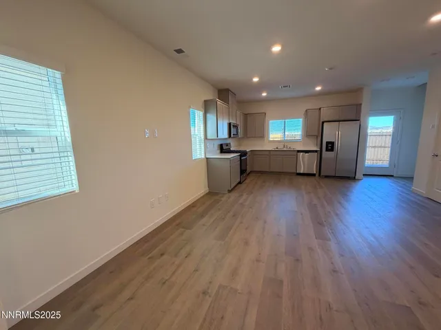 a view of a kitchen with a sink and wooden floor