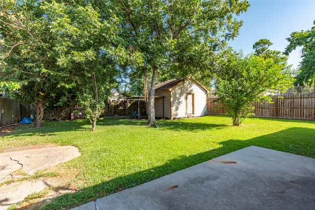 a house with green field in front of it
