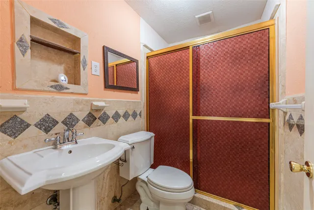 a bathroom with a sink toilet and mirror