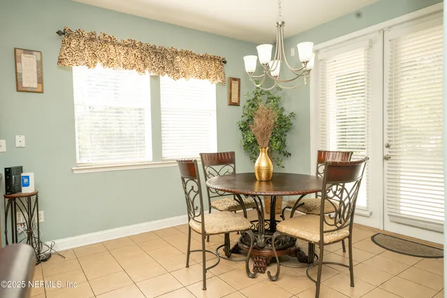 a view of a dining room with furniture and a chandelier