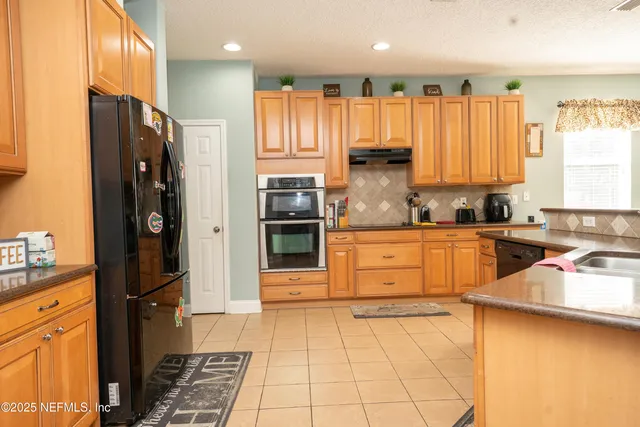 a kitchen with a refrigerator and a sink