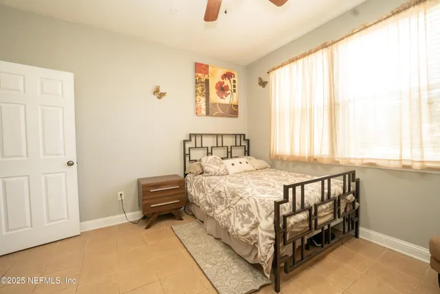 a bedroom with a bed and a window