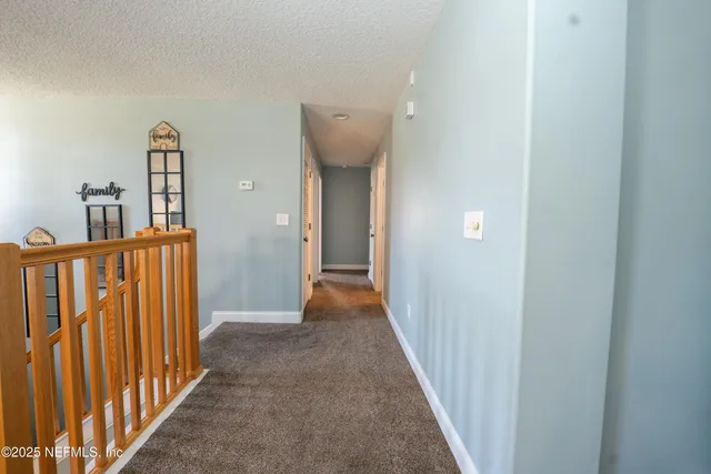 a view of a hallway with entryway door