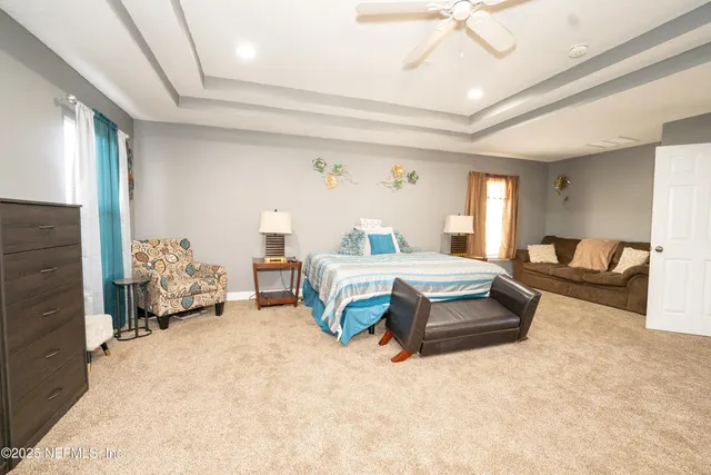 a bedroom with bed and a chandelier