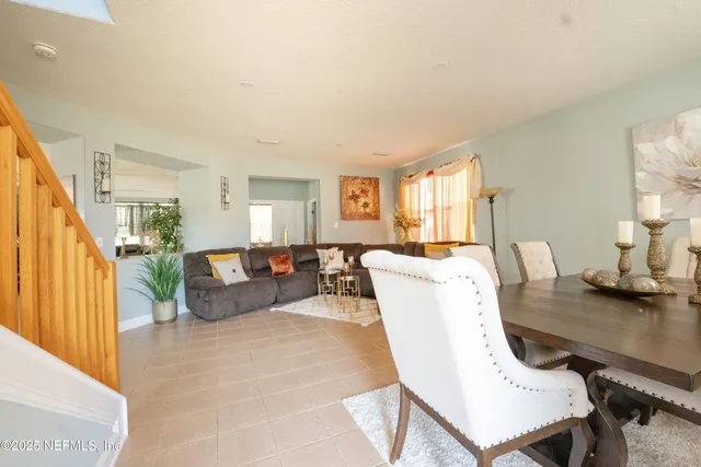 a living room with furniture rug and wooden floor