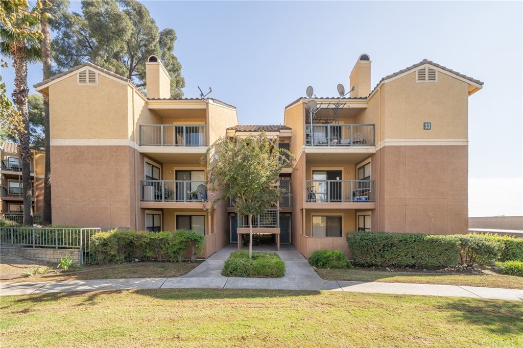 10655 Lemon Avenue, Unit 3304 Rancho Cucamonga, CA 91737 - Photo 1 of 1 a front view of a residential houses with yard