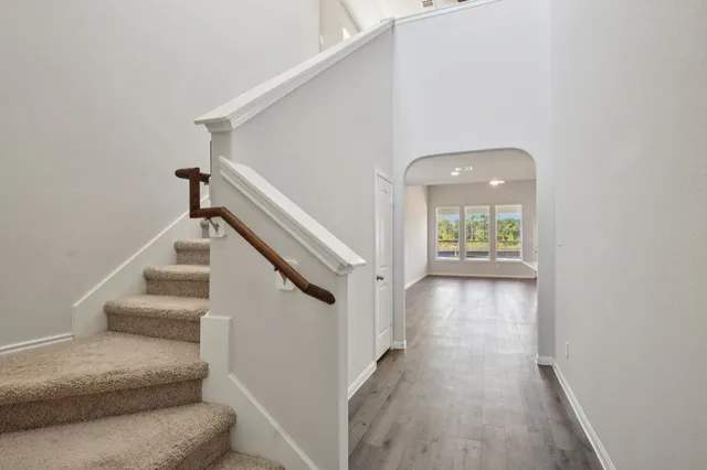 a view of entryway and hall with wooden floor