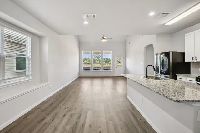 a view of a kitchen with a sink and wooden floor