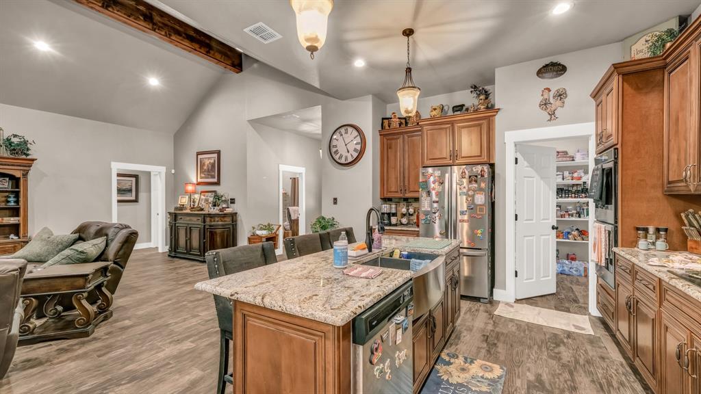 143 Oak Tree Drive Poolville, TX 76487 - Photo 14 of 40 a open kitchen with cabinets a stove and chairs