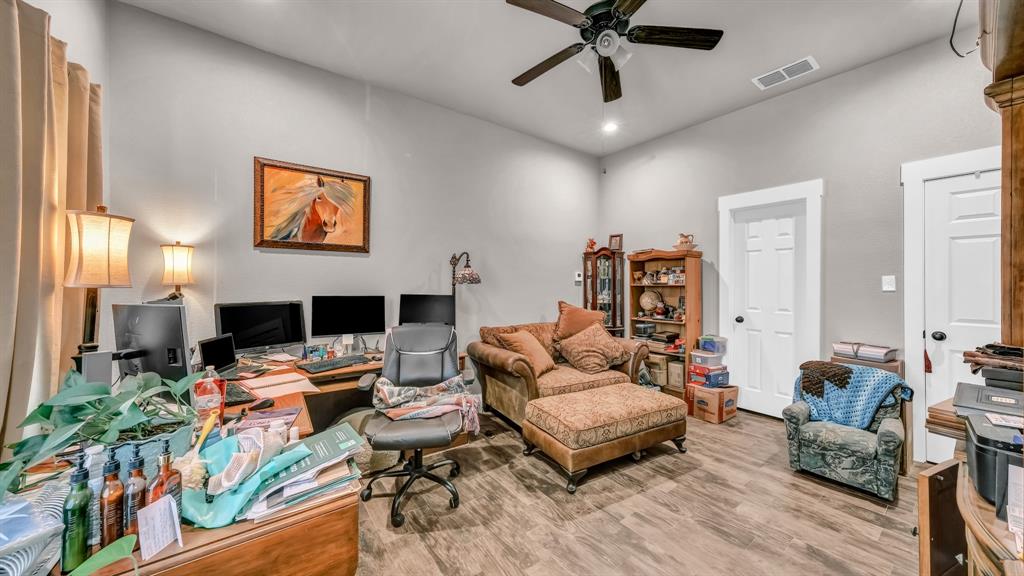 143 Oak Tree Drive Poolville, TX 76487 - Photo 24 of 40 a living room with furniture and a flat screen tv