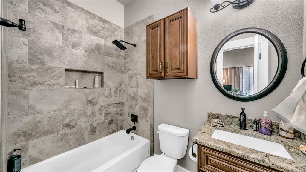 143 Oak Tree Drive Poolville, TX 76487 - Photo 25 of 40 a bathroom with a sink a toilet and a mirror