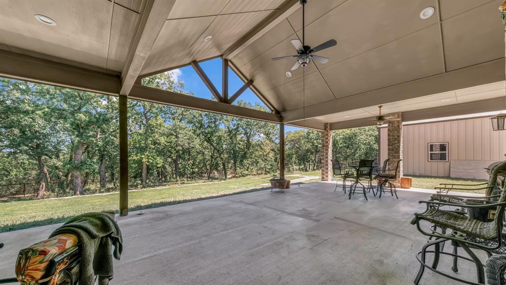 143 Oak Tree Drive Poolville, TX 76487 - Photo 29 of 40 a view of a porch with chairs and backyard