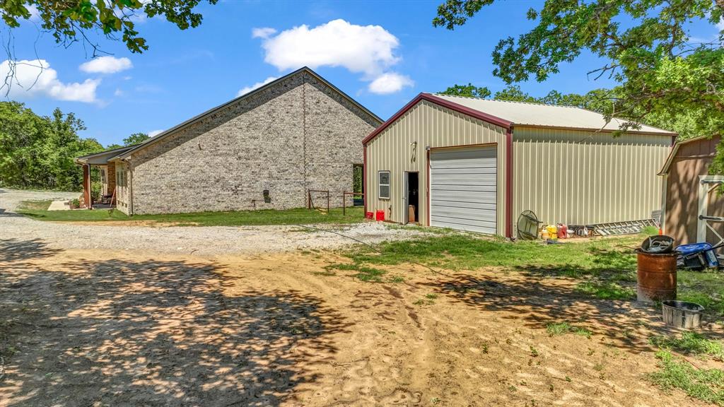 143 Oak Tree Drive Poolville, TX 76487 - Photo 36 of 40 a view of a house with a yard