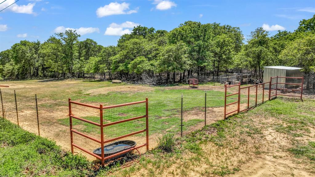 143 Oak Tree Drive Poolville, TX 76487 - Photo 38 of 40 a view of a backyard with wooden fence