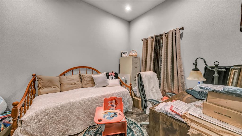 143 Oak Tree Drive Poolville, TX 76487 - Photo 6 of 40 a bedroom with furniture and a bed