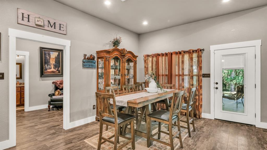 143 Oak Tree Drive Poolville, TX 76487 - Photo 10 of 40 a view of a dining room with furniture and wooden floor