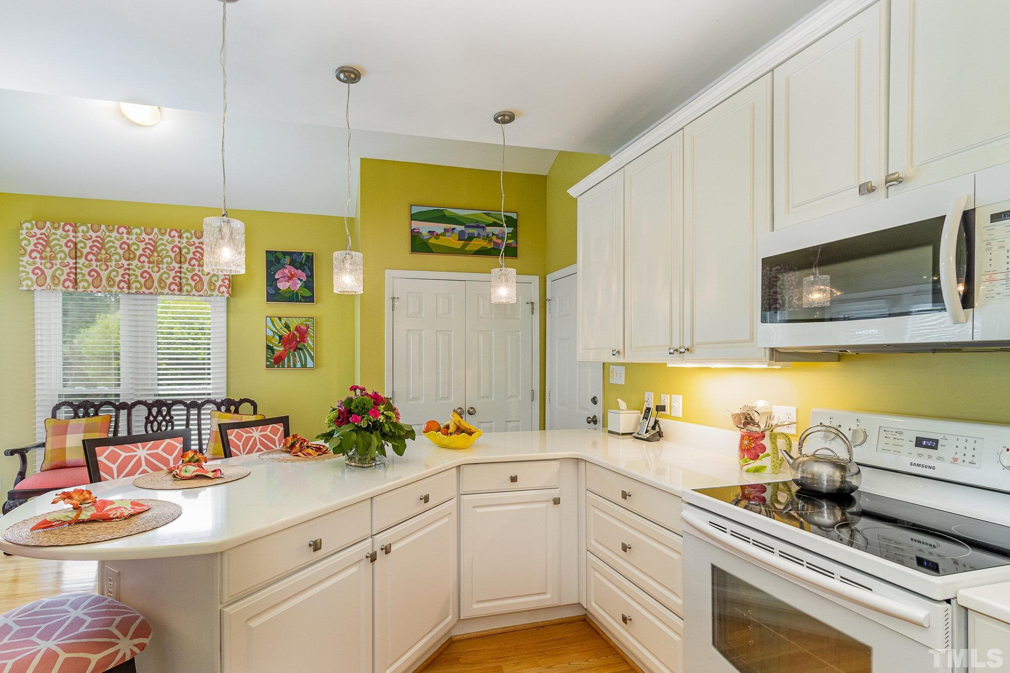 313 Boltstone Court Cary, NC 27513 - Photo 12 of 28 a kitchen with a sink stove and microwave