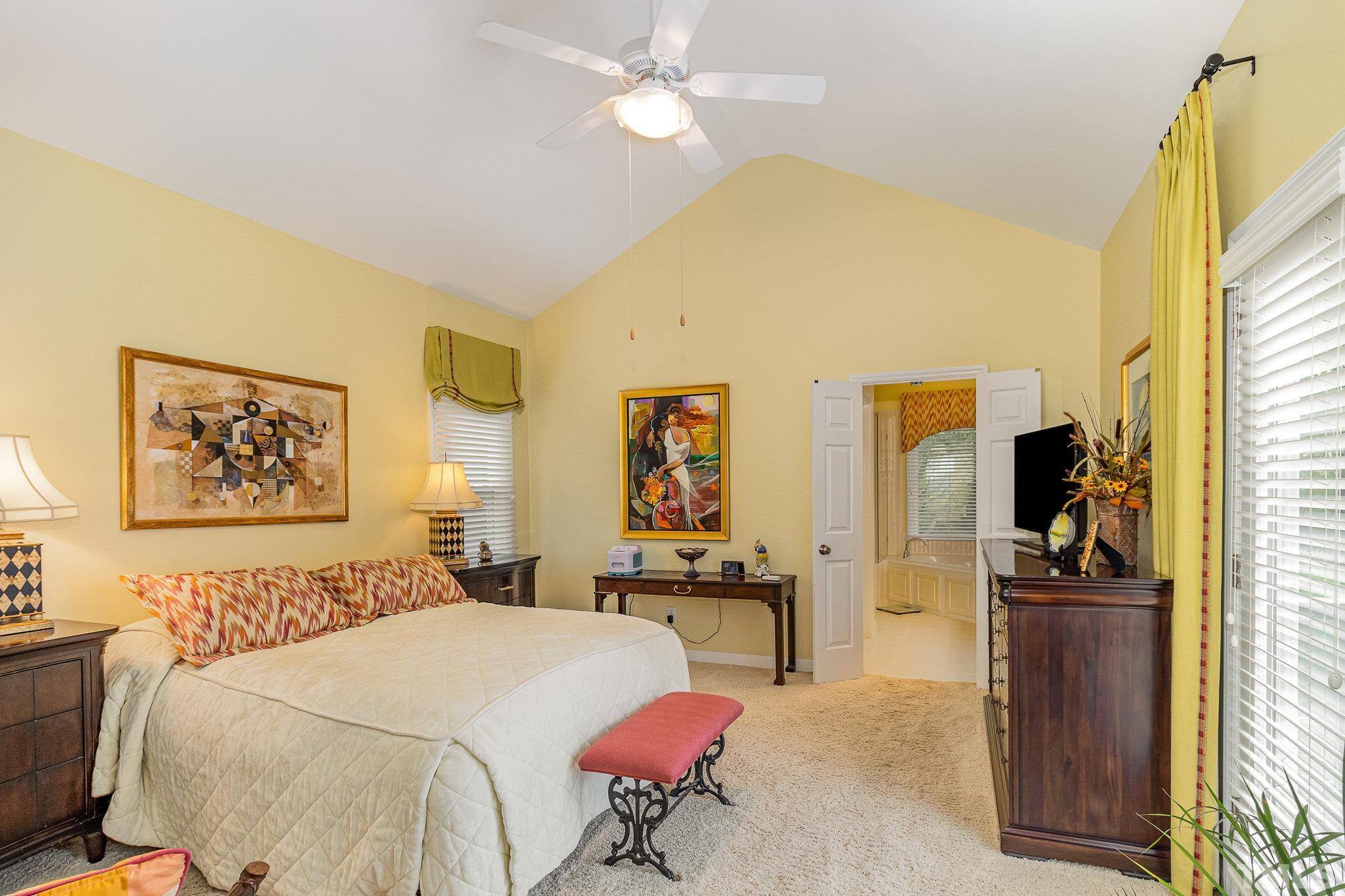 313 Boltstone Court Cary, NC 27513 - Photo 13 of 28 a bedroom with a bed and a chandelier