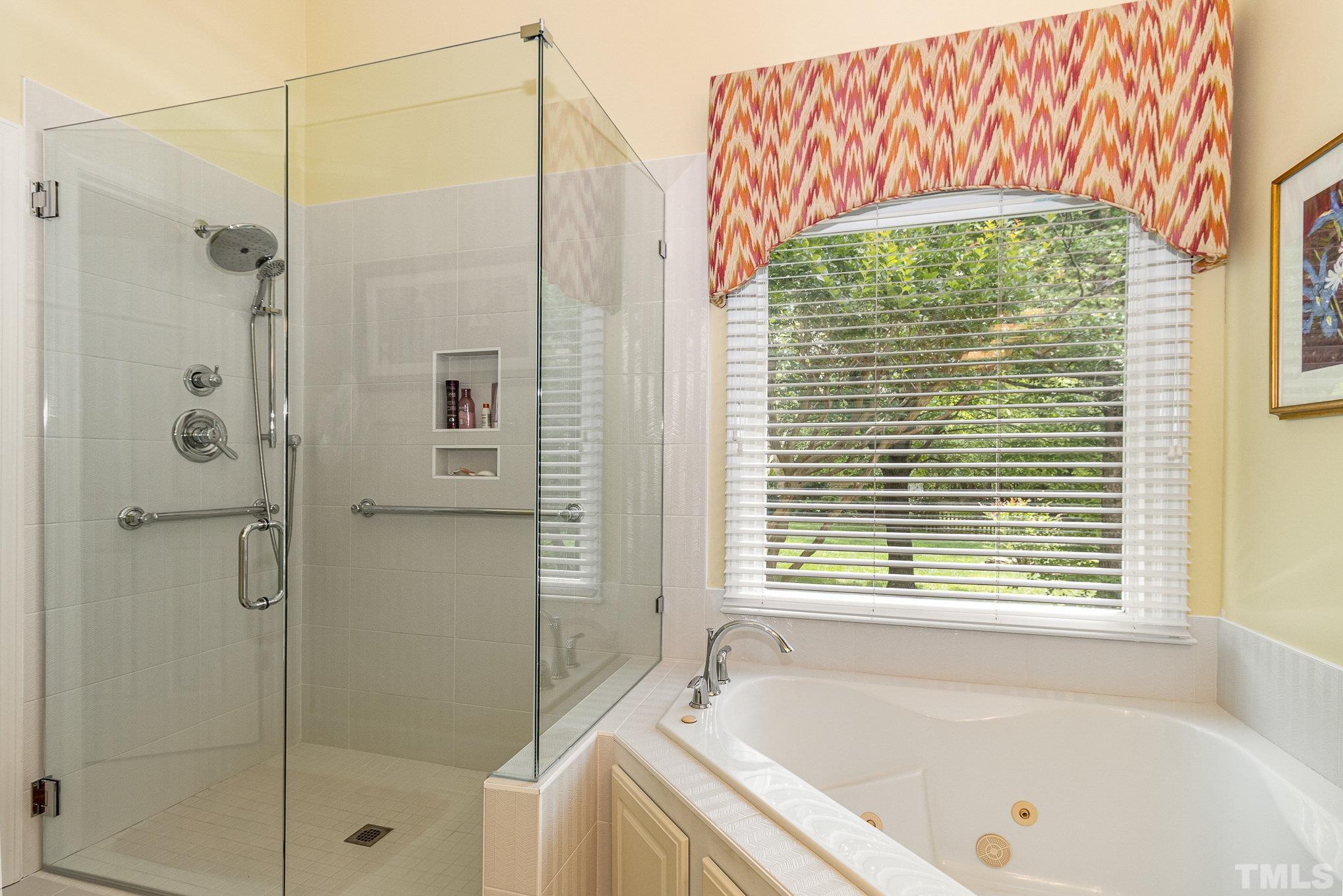 313 Boltstone Court Cary, NC 27513 - Photo 16 of 28 a bathroom with a bathtub and shower