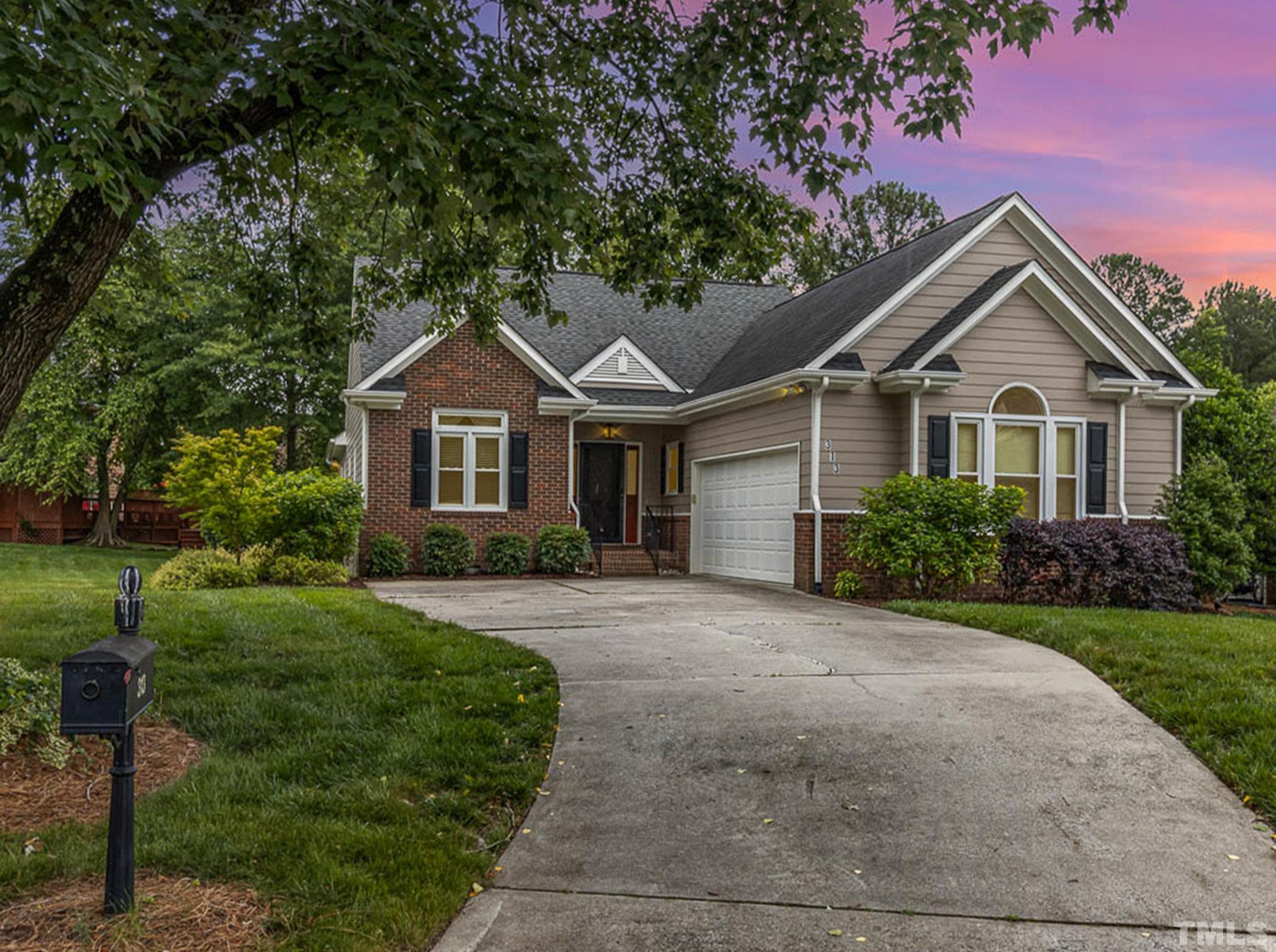 313 Boltstone Court Cary, NC 27513 - Photo 2 of 28 a front view of a house with a yard and trees