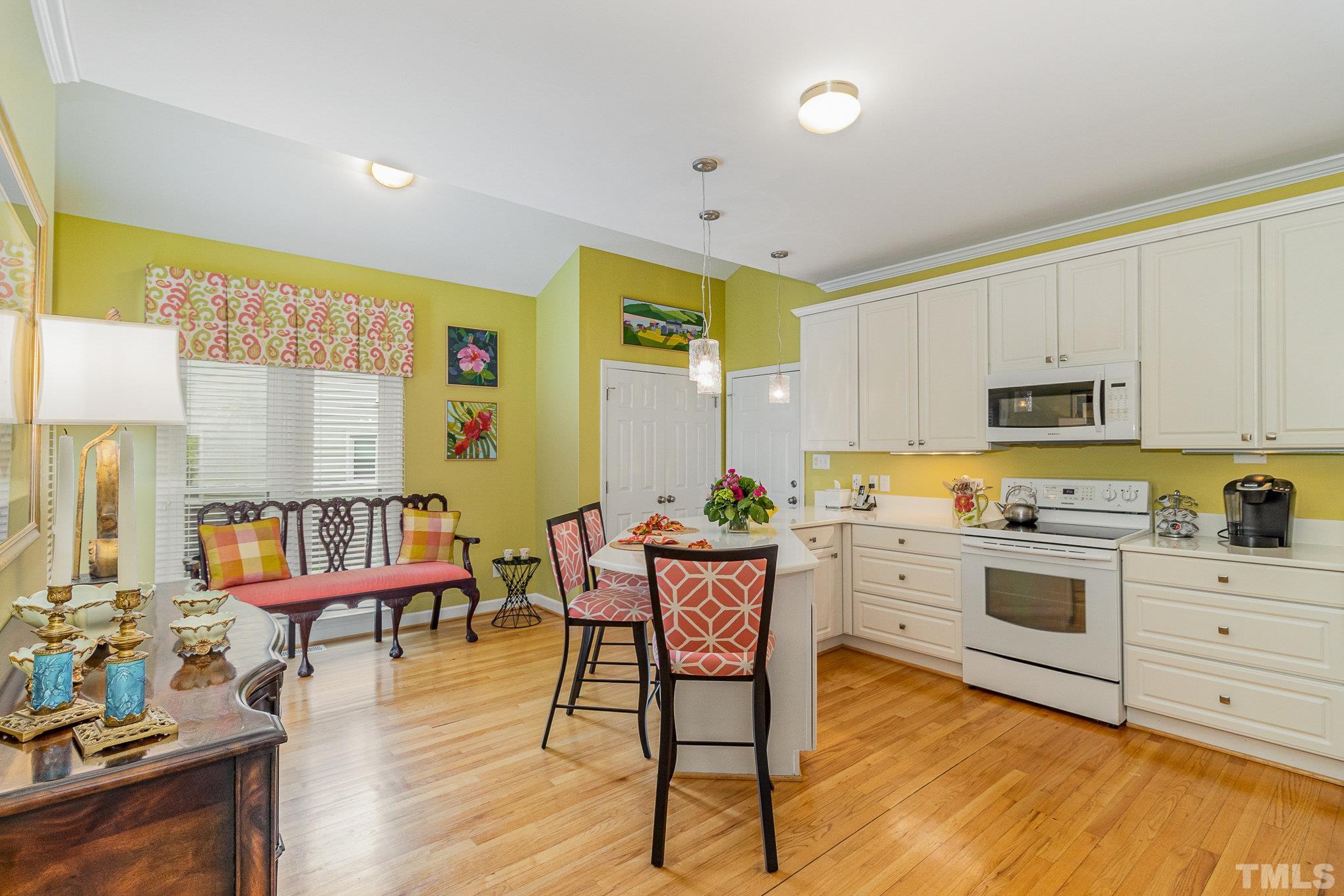 313 Boltstone Court Cary, NC 27513 - Photo 10 of 28 a kitchen with sink cabinets and wooden floor