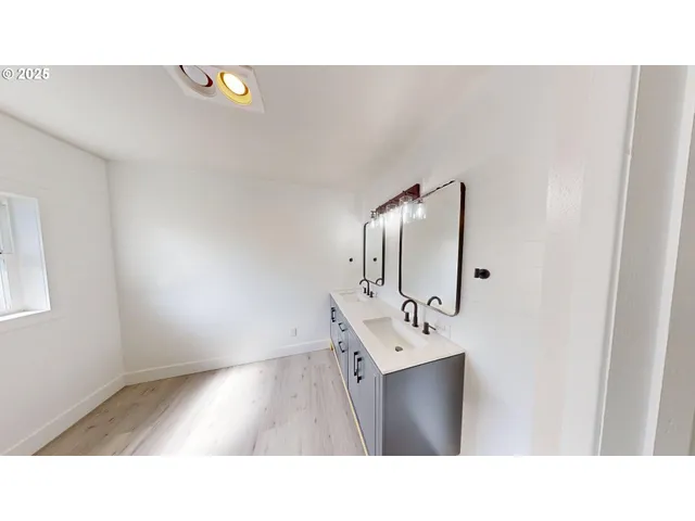 a bathroom with a sink and mirror