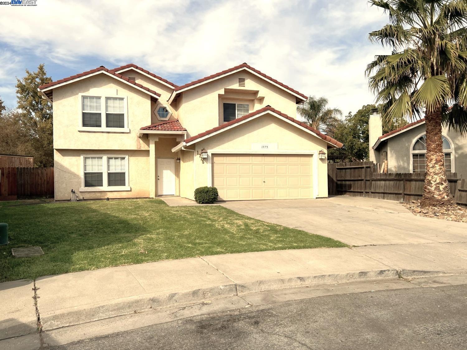 95377 Scott Tracy, CA 93577 - Photo 41 of 46 a front view of a house with a yard and garage