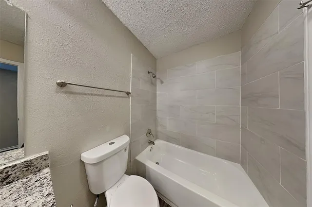 a bathroom with a toilet and a bathtub