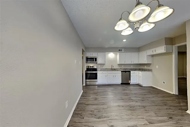 a view of kitchen with wooden floor