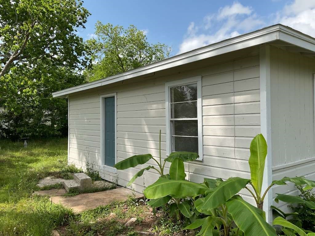 1156 2nd Street Clute, TX 77531 - Photo 14 of 15 a front view of a house with garden