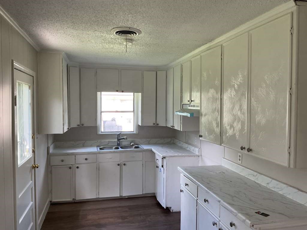 1156 2nd Street Clute, TX 77531 - Photo 4 of 15 a kitchen with a sink window and cabinets