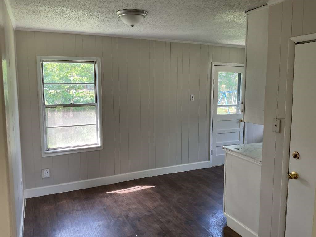 1156 2nd Street Clute, TX 77531 - Photo 5 of 15 an empty room with wooden floor and windows