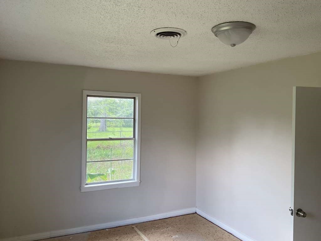 1156 2nd Street Clute, TX 77531 - Photo 7 of 15 a view of an empty room with window and closet area