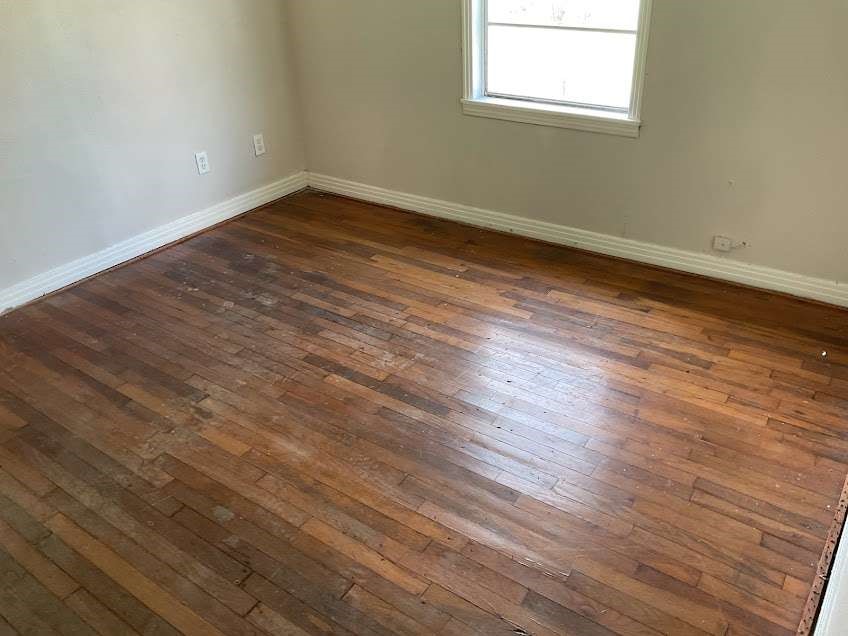1156 2nd Street Clute, TX 77531 - Photo 8 of 15 a view of a room with wooden floor and windows
