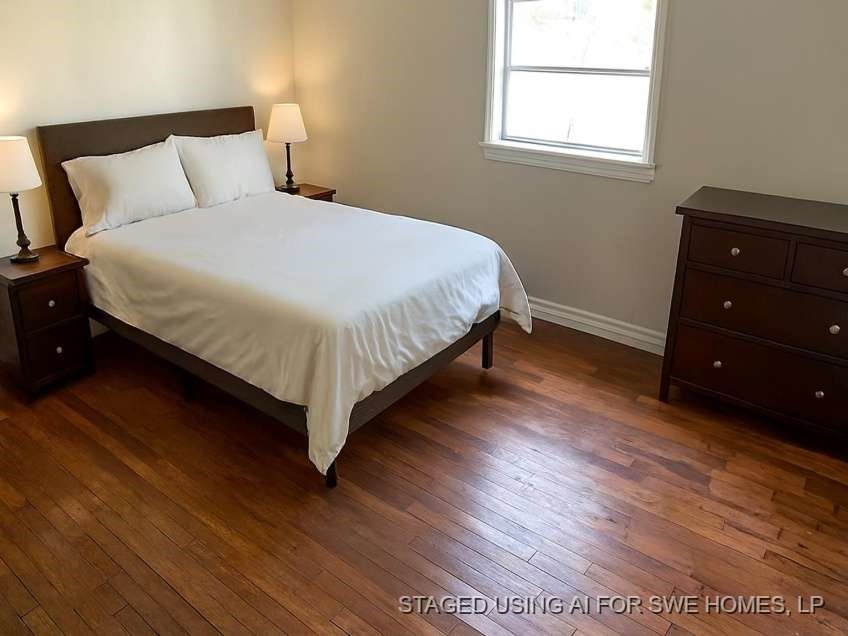 1156 2nd Street Clute, TX 77531 - Photo 9 of 15 a bedroom with a bed and a window