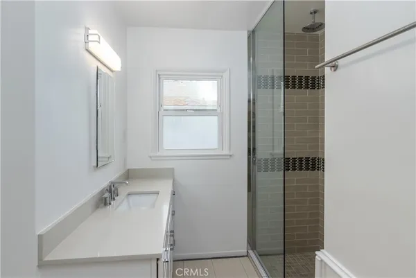a bathroom with a sink and shower