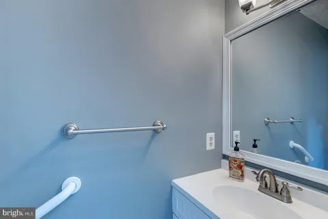 a bathroom with a sink vanity and a mirror