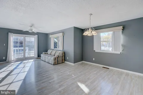 a living room with hard wood floors and a window