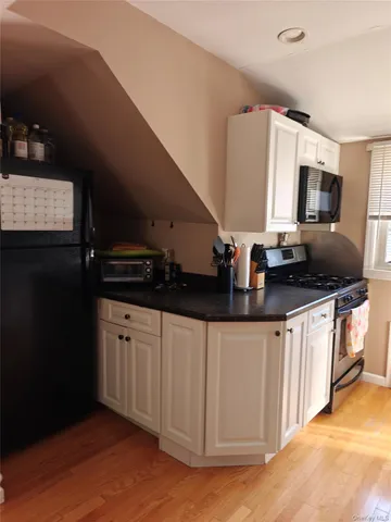 a kitchen with granite countertop a sink and a stove top oven