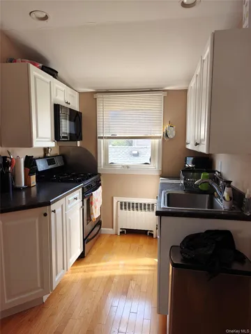 a kitchen with a window a sink and a stove