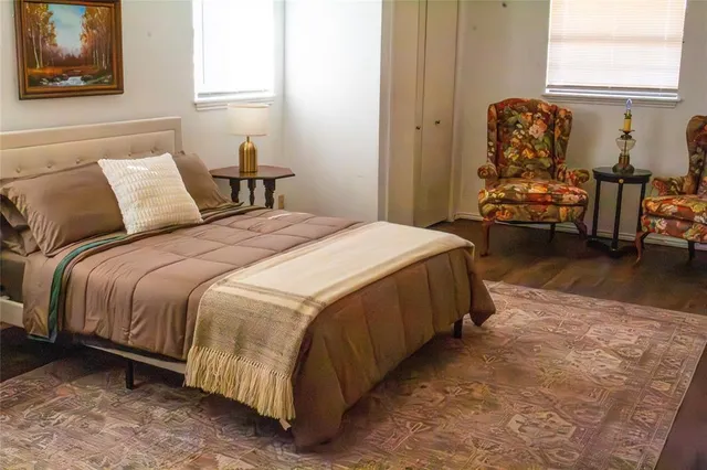 a bedroom with a bed mirror and a window