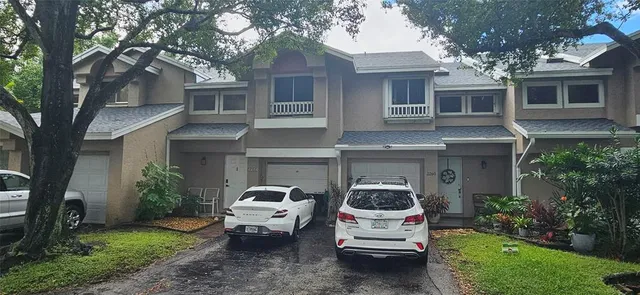 a car parked in front of white house