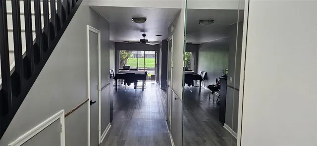 wooden floor with dining room and stairs