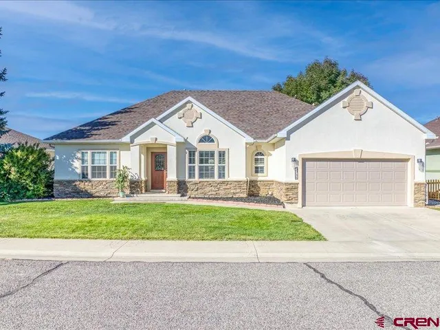 a view of a house with a yard and pathway