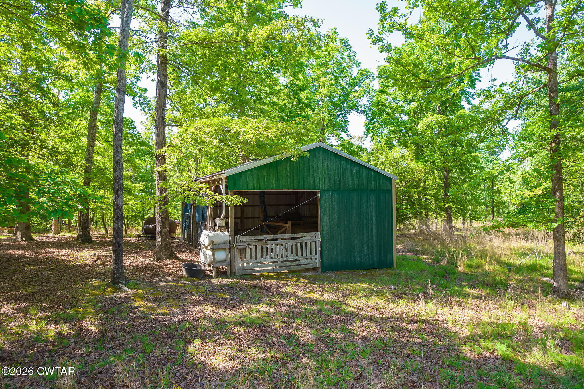 9402 Brooksie Thompson Road Bath Springs, TN 38311 - Photo 16 of 19 a backyard of a house with table and chairs