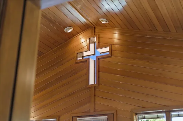 a view of a hallway with wooden fence