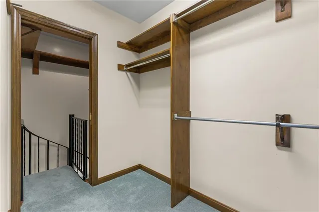 a view of staircase with white walls and a window