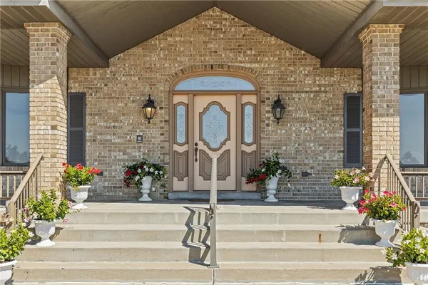 a front view of a house with a fountain