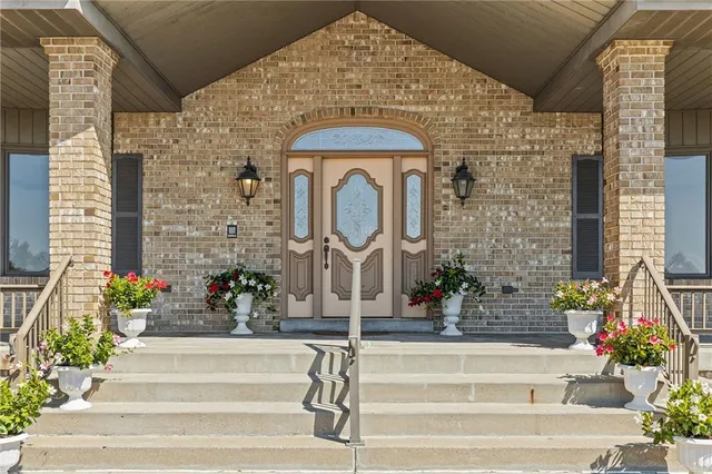 a front view of a house with a fountain