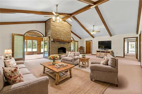 a living room with furniture a fireplace and a flat screen tv